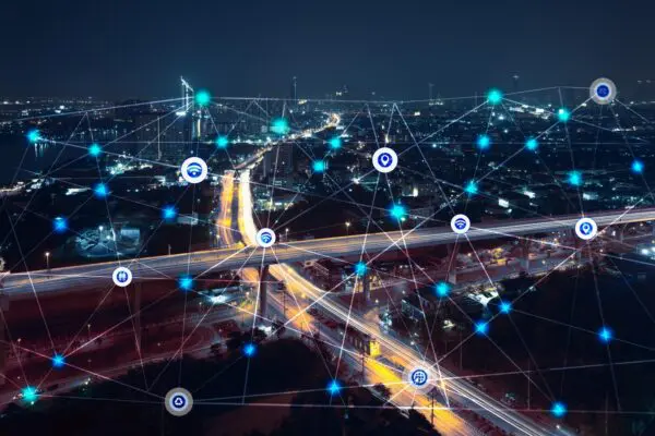 city at night with communication icons and network lines mix media concept background